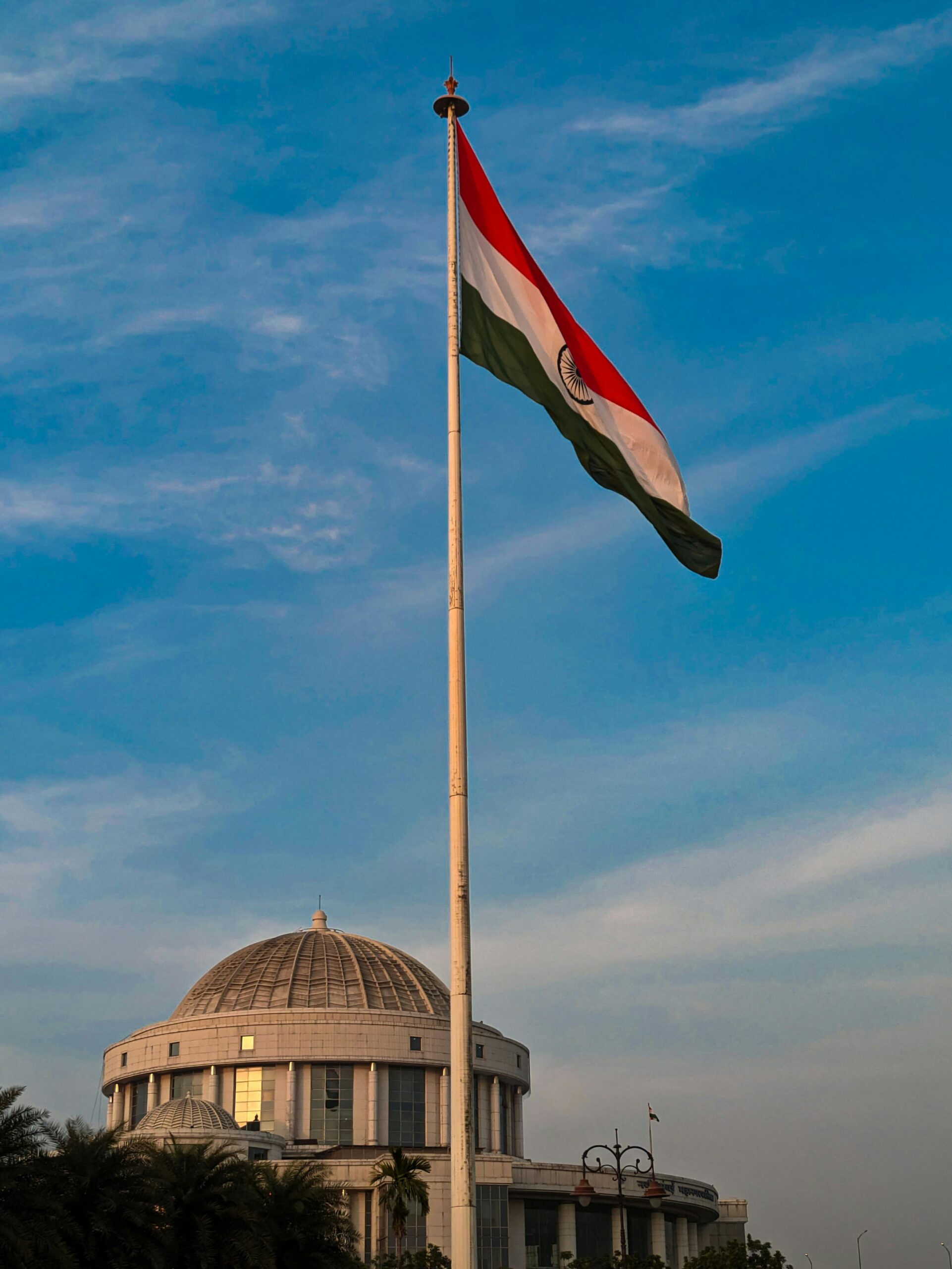 The iconic Indian flag waving high at Navi Mumbai's municipal landmark under clear skies.